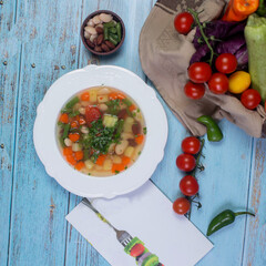 Vegetable soup served with minced herbs, top view