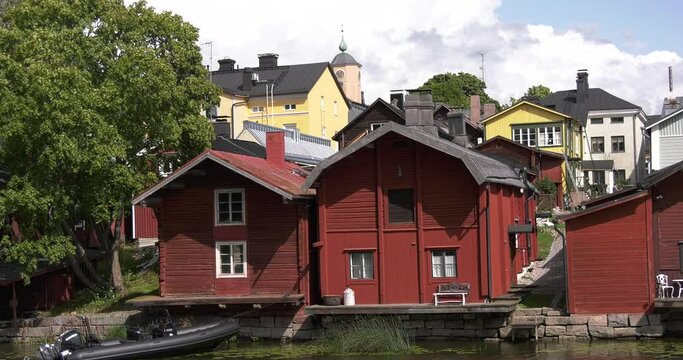 4K video of Porvoo vintage red wooden buildings, Porvoo Cathedral, yachts and boats in Porvoonjoki River near town center on sunny summer day in Finland, northern Europe