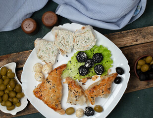 Roll salad with pastry and olives. top view