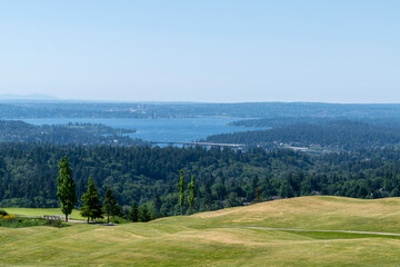 View over Lake Washington towards East Seattle from Newcastle Golf Course on a spring day; highway bridges I-90 and 520 across the lake can be partially seen and the golf course.