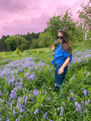 photo of a young girl in a summer field in flowers