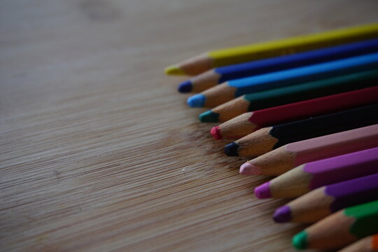 Arrangement of colored pencils on wooden background. copy space for text. back to school concept. rustic vintage concept
