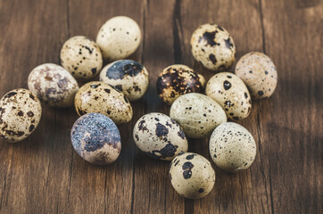 Quail bird eggs on a wooden board