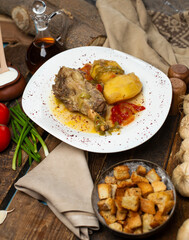 delicious meat and potato meal with wooden background