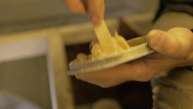 Mixing fiber glass and hardener together on lid