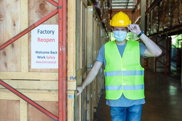 factory worker with business reopen notice after coronavirus pandemic