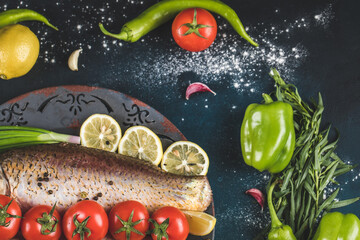 Raw fish meat with green chilies, lemon and tomatoes, top view