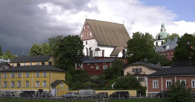 4K video of Porvoo vintage red wooden buildings, Porvoo Cathedral, yachts and boats in Porvoonjoki River near town center on sunny summer day in Finland, northern Europe