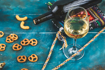 Pretzel biscuits with a glass of white wine, top view