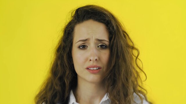 Disappointed Woman Almost Crying Portrait On Yellow Background