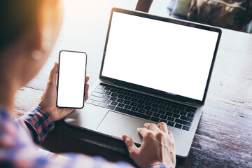 computer,cell phone mockup image.hand woman work using laptop texting mobile.blank screen with...