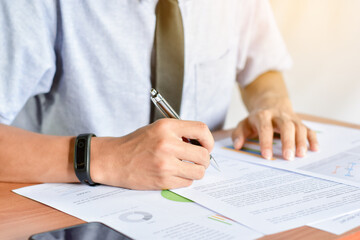 Business people sign documents on the table and hand with pen signing contract / signature