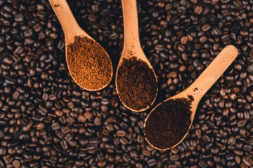 Ground coffee in a spoon on the background