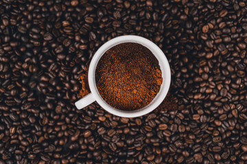 Ground coffee in a spoon on the background