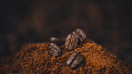 Ground coffee in a spoon on the background