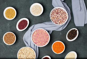 Red lentil beans, rice, buckwheat and sumakh herbs in a white bowl on the table