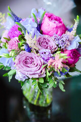 Peonies bridal bouqueton a table. Pink and purple colours