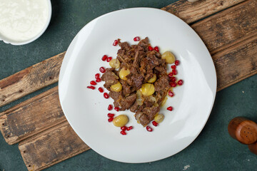 Meat sauteed with chestnuts and pomegranate seeds , top view