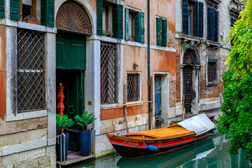 Fototapeta na wymiar Gondolas along buildings on Grand Canal of Venice Italy