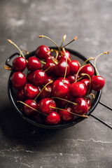 Ripe and juicy cherries on the dark rustic background. Selective focus. Shallow depth of field.