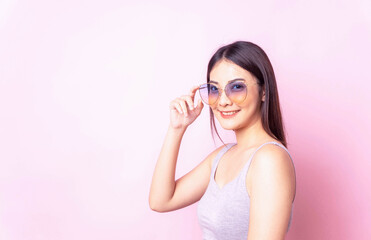 Healty young asian woman with sunglasses summer season , isolated portrait girl pink color background.,female fashion model