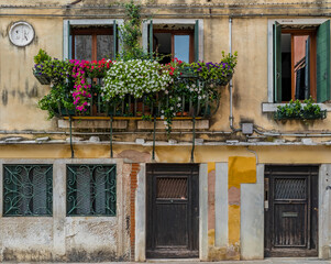 Exterior of an old building with shutters and ornate windows in Venice Italy