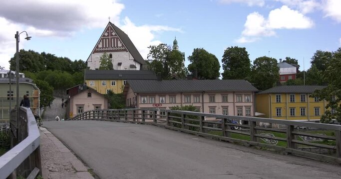 4K video of Porvoo vintage red wooden buildings, Porvoo Cathedral, yachts and boats in Porvoonjoki River near town center on sunny summer day in Finland, northern Europe