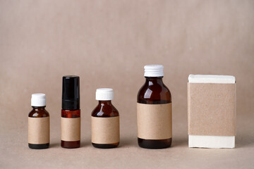 Set of cosmetic dark amber glass bottles with paper craft label for mock up. Closeup, copyspace. Beauty blogging, salon treatment concept, minimalism brand packaging