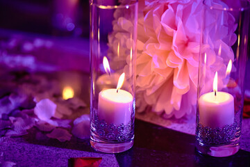 Purple Candles and flowers as decorations at night wedding ceremony