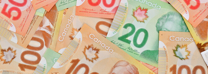 Close up shot of Canadian dollars banknotes background, concept of business and financial,banner...