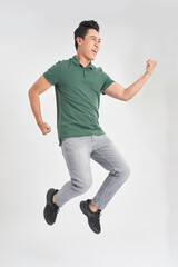Fototapeta na wymiar Full-length photo of funny man 30s in casual t-shirt and jeans running or jumping in air isolated over white background