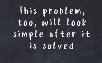 Chalk wise inscription on black chalkboard