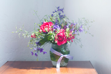 Bouquet of pink flowers in a vase. On the table. Spring and summer flowers. Still life