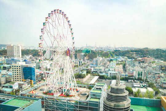 Ulsan,South Korea-April 2018: View of ferris wheel on top of Lotte Department Building from a window.