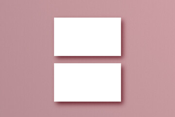 Business card template on pink pastel background.