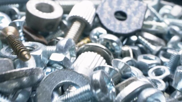 super close. nut and bolt parts, fasteners in a heap