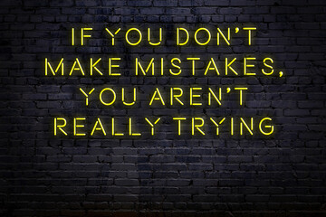 Smart and motivational quotation. Neon sign on brick wall