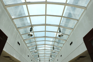 A mall utilizing a skylight roof or glass ceiling to allow sunlight to shine through as natural...
