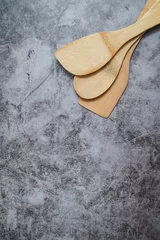 Fototapeten Stacked of spatulas on textured surface. © fotoverse