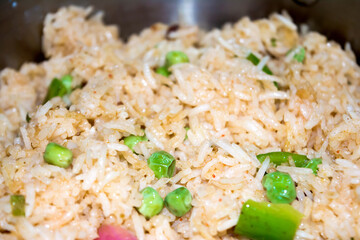 Homemade Chinese fried rice with vegetables, Veg Schezwan Fried Rice, peas, peppers, green beans, carrot. Selective Focus, Top view
