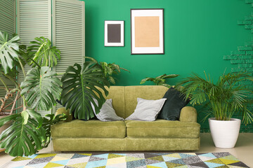 Stylish sofa with houseplants in interior of living room © Pixel-Shot
