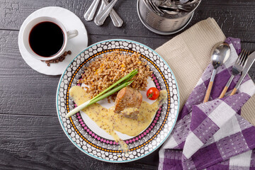A piece of boiled beef with mushroom sauce and buckwheat