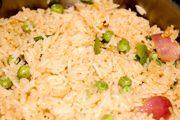 Homemade Chinese fried rice with vegetables, Veg Schezwan Fried Rice, peas, peppers, green beans, carrot. Selective Focus, Top view
