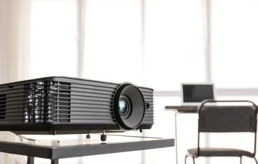 Video projector on table in conference hall
