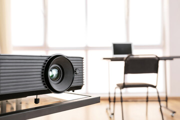 Video projector on table in conference hall