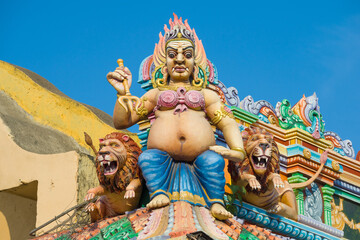 Sculpture of Shiva with a trident and lions in the decoration of the ancient Hindu temple  of Sri...
