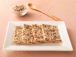 Plate with cereal cookies on color background