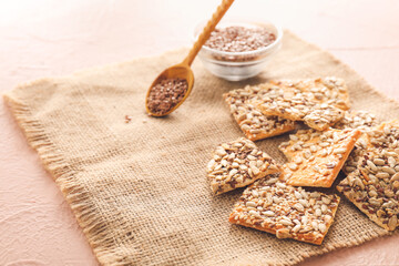 Cereal cookies and flax seeds on color background