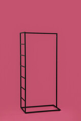 Stylish clothes hanger on color background