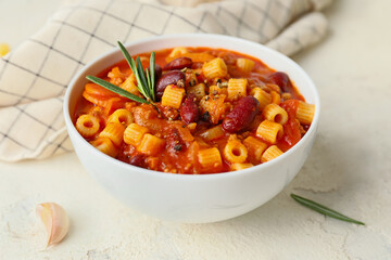 Bowl with tasty pasta and beans on white background